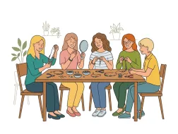 Ilustracja przedstawia grupę pięciu kobiet siedzących przy wspólnym stole podczas warsztatów rękodzielniczych. Uczestnicy tworzą biżuterię z koralików – nawlekają bransoletki i naszyjniki, rozmawiając i uśmiechając się do siebie. Na stole znajdują się miseczki z koralikami, szczypce, druciki i gotowe ozdoby. Jedna z osób trzyma lusterko i ogląda wykonaną biżuterię. W tle widoczne są rośliny doniczkowe, a całość utrzymana jest w ciepłym, przyjaznym stylu ilustracyjnym.