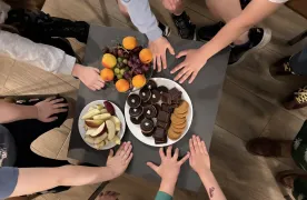 Dziecięce ręce sięgające po owoce i ciastka