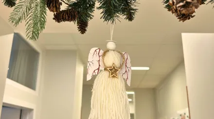 Sznurkowy aniołek wiszący na girlandzie w korytarzu Poradni